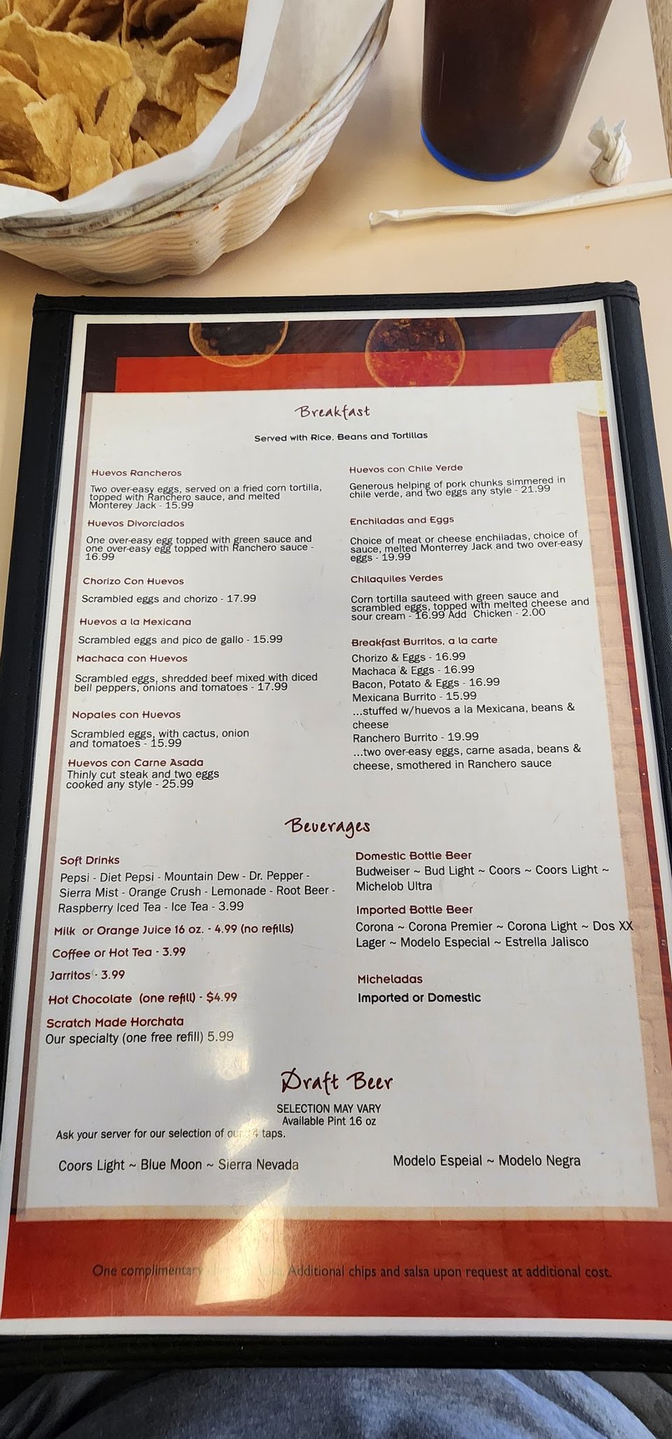 Printed menu with burritos, seafood, and enchiladas.